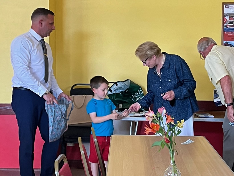 Our new chair, Jeff Wilton Love and stalwart member, Suscan Collins, draw the raffle with the help of Councillor Dermot McGough's little boy.